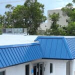 Blue metal roofing panels on commercial building.